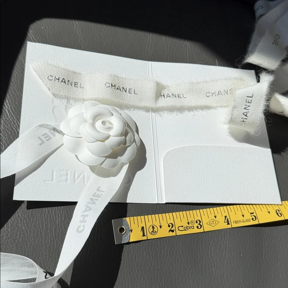 CHANEL 1 CAMELIA FLOWER AND Silver Chanel printed RIBBON,  plus Chanel card.